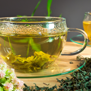 : Close-up of a glass cup of horehound tea with dried and fresh horehound leaves.