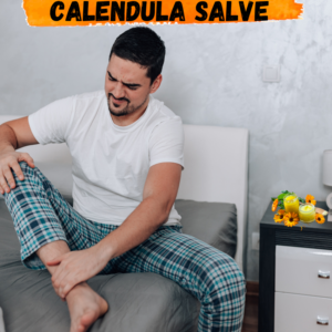  Man applying calendula salve to his ankle while seated on a bed.