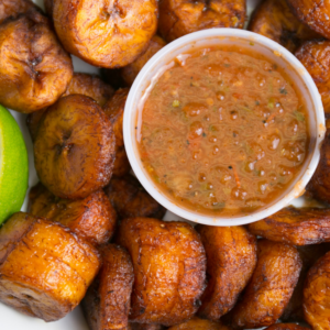 Cooked plantains arranged around a bowl of dipping sauce.